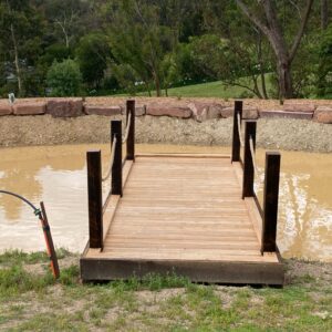 Cypress 140x35mm Sawn Face Decking – Rustic, durable boards ideal for wharf-style structures and outdoor settings, shown installed over a pond with rope rail posts